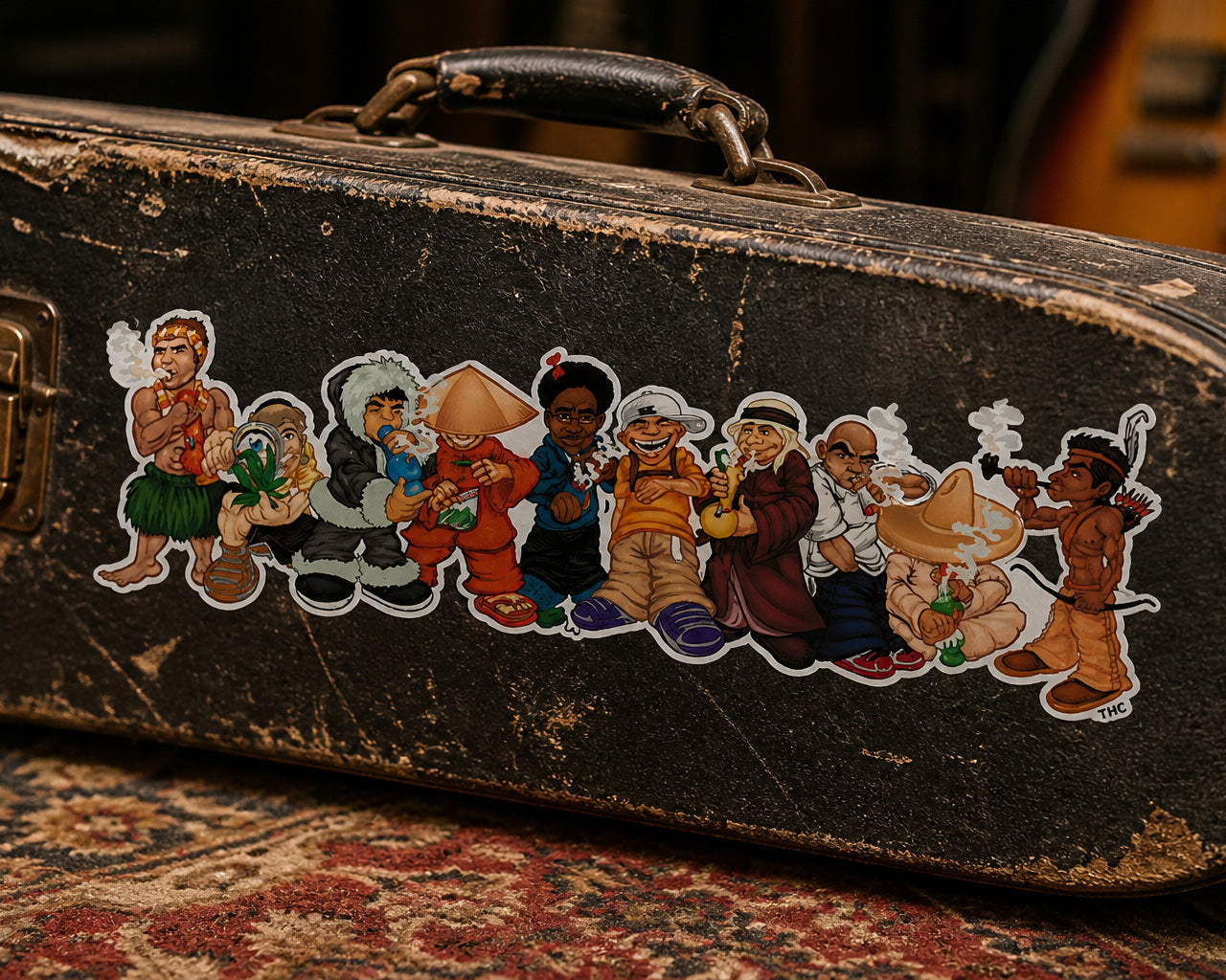 THC World Crew sticker on worn black guitar case with scratches metal latches and studio setting