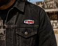 THC Lone Star patch sewn onto black denim jacket chest pocket with worn vintage texture