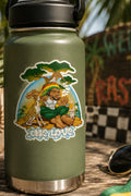 THC Rastaland Sticker on a green water bottle in a tropical outdoor setting