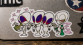 THC Alien Quartet sticker across scratched silver laptop with moody studio lighting