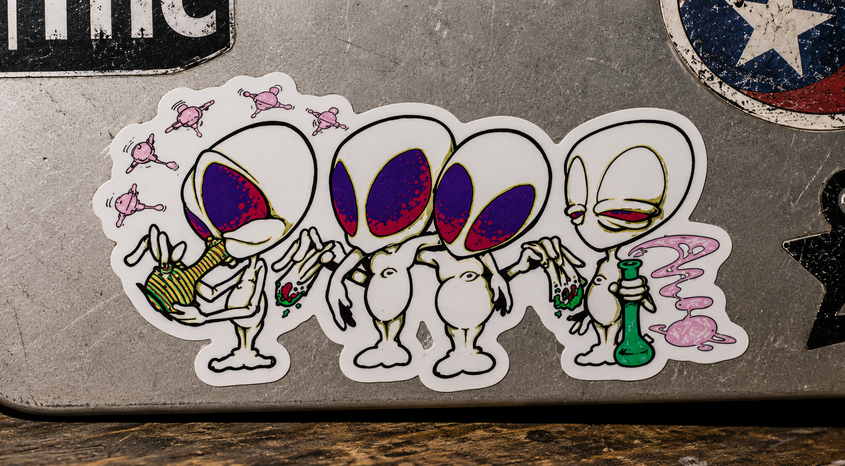 THC Alien Quartet sticker across scratched silver laptop with moody studio lighting