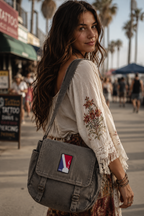 THC NBA Patch displayed on a gray canvas satchel carried by a woman at the beach, featuring a bold red, white, and blue embroidered sports-inspired design