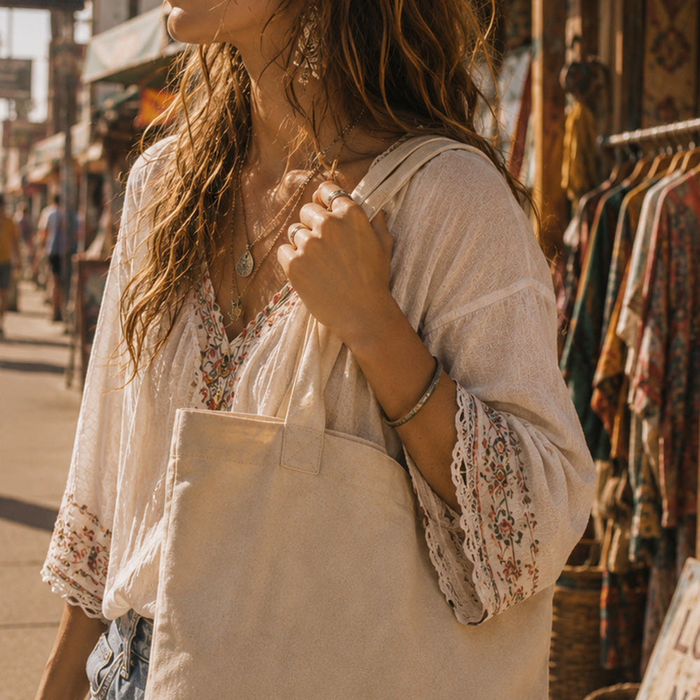 THC 420 Sun Patch displayed on a natural canvas tote bag carried by a young bohemian woman on the Venice Beach boardwalk, featuring a retro embroidered 420 sun design in yellow, orange, blue, and white