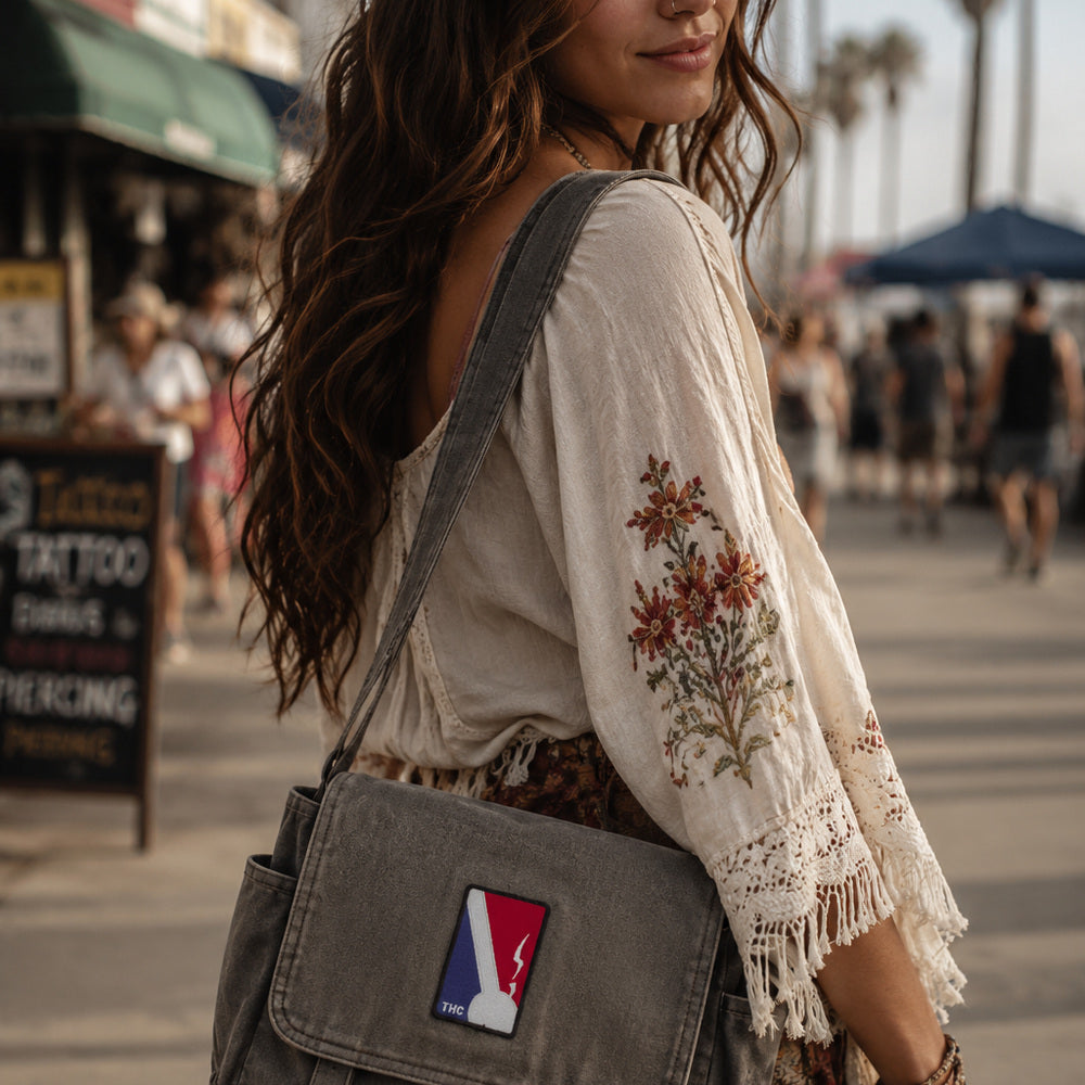 THC NBA Patch displayed on a gray canvas satchel carried by a woman at the beach, featuring a bold red, white, and blue embroidered sports-inspired design