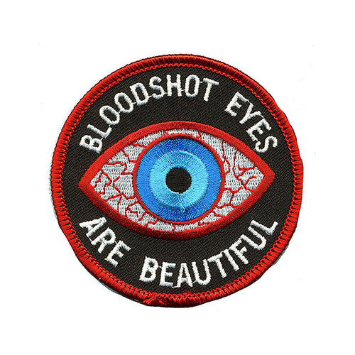 THC Bloodshot Patch featuring an embroidered blue eye with red and white detailing and the phrase “Bloodshot Eyes Are Beautiful” on a black circular background.