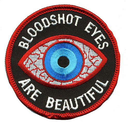 THC Bloodshot Patch featuring an embroidered blue eye with red and white detailing and the phrase “Bloodshot Eyes Are Beautiful” on a black circular background.