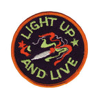 THC Light Up Patch featuring an embroidered smoking joint with swirling smoke and green lettering on a black circular background