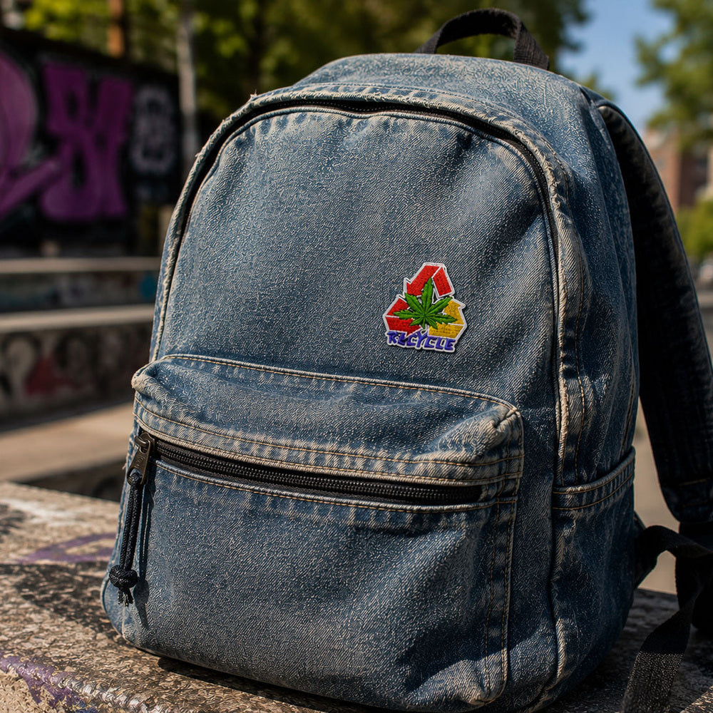 THC Recycle Leaf patch sewn onto faded denim backpack with outdoor urban setting