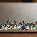 THC Mushrooms sticker stretched across bottom edge of worn laptop with scratches and multiple decals