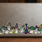 THC Mushrooms sticker stretched across bottom edge of worn laptop with scratches and multiple decals