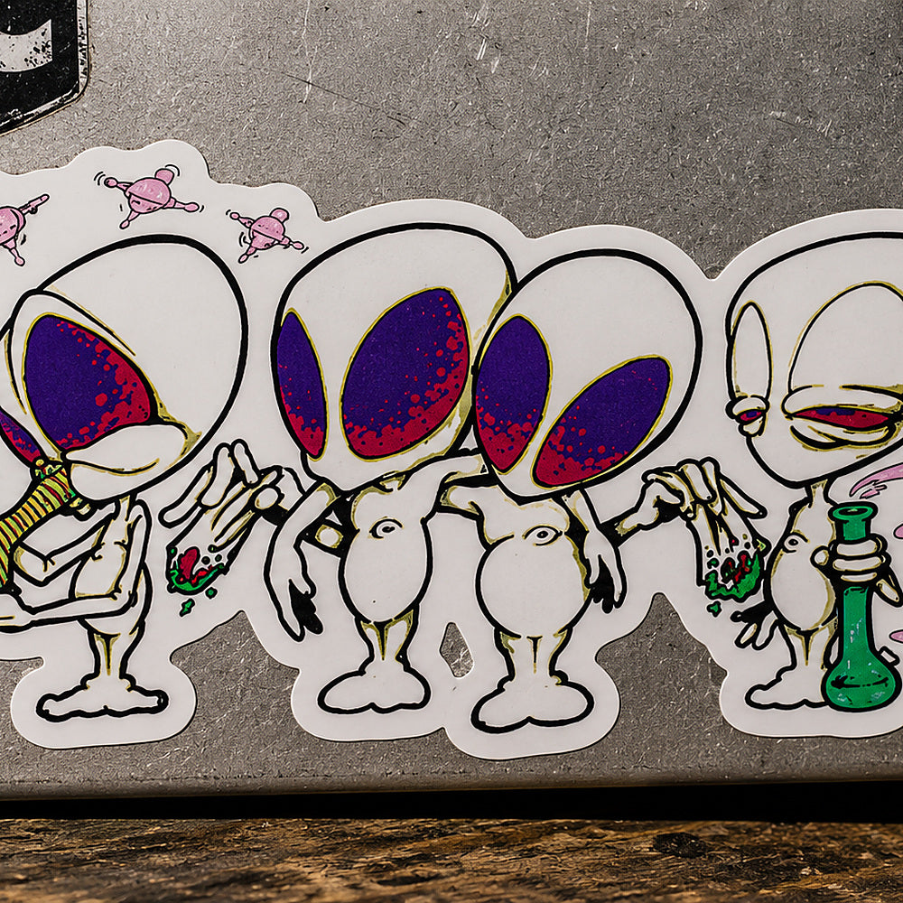 THC Alien Quartet sticker across scratched silver laptop with moody studio lighting