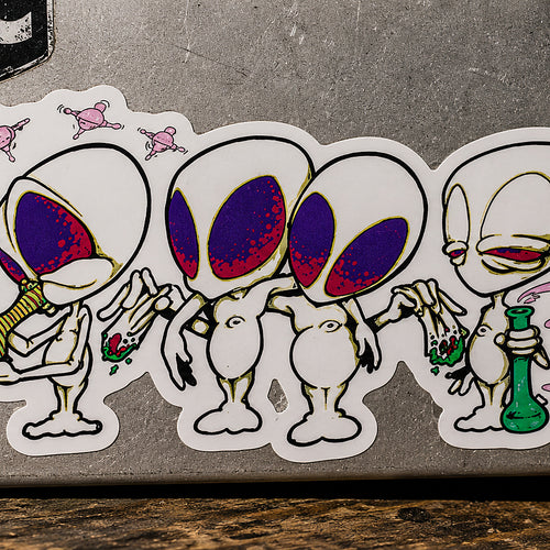 THC Alien Quartet sticker across scratched silver laptop with moody studio lighting