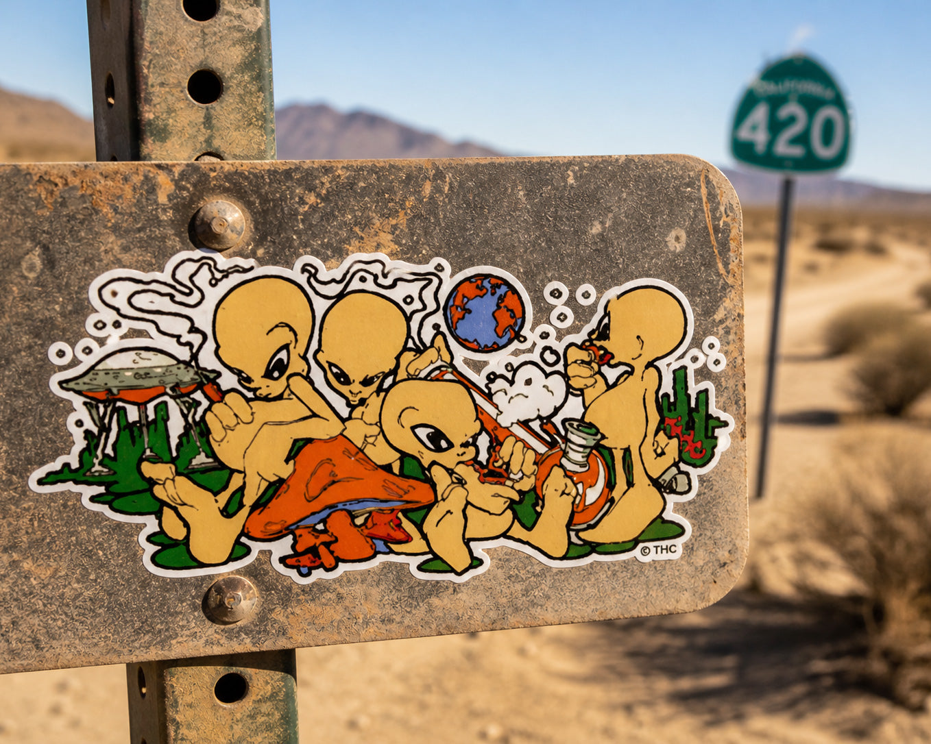 THC Alien Posse sticker placed on dusty metal road sign in desert landscape with sun and sand backdrop