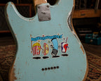 THC Intermission sticker on worn robin’s egg blue Mustang guitar with chipped paint and studio background